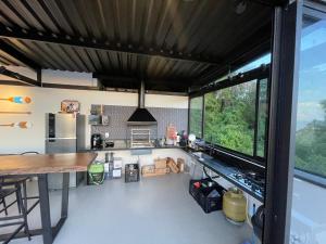 a kitchen with a counter and a large window at Reserva Santa Helena in Anchieta