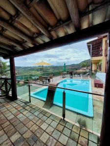 a swimming pool with a view of a resort at Pousada Inconfidência Mineira in Ouro Preto