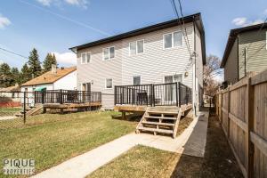 a house with a deck and a fence at *Vibrant Suite* Long Stays - Wi-Fi - Fireplace - NFLX in Edmonton
