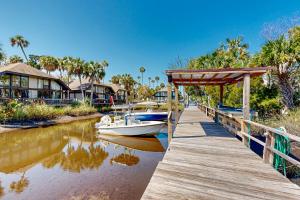 a boat is docked on a dock next to a house at Peaceful River Bungalow in Crystal River