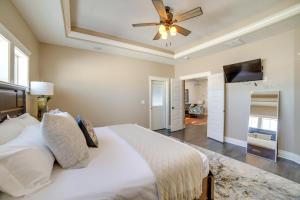 a bedroom with a white bed and a ceiling fan at Welcoming Rigby Home with Game Room and Fire Pit! in Rigby