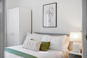 a bedroom with a bed with white pillows at NEW 5 Sarah House by Truestays - 2 Bedroom Apartment - FREE Parking in Manchester
