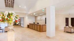 a lobby with a reception desk and a flower arrangement at HOTEL HOLISTIC RESORT - Vacation STAY 34557v in Taiji