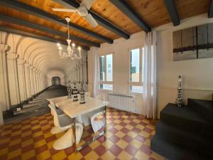 a room with a table and chairs and a staircase at Privilege Menorca Apartment in Mahón