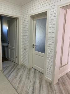 an empty room with a door and a bathroom at Люкс 2-х комнатная квартира in Taraz