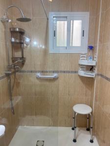 a bathroom with a shower with a stool and a sink at Apartment zona Naturista in Vera