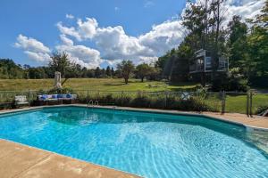 a large swimming pool in front of a house at Garage Cottage in Gilford
