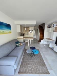 a living room with a couch and a table at Perle d'or vue mer in Saint-Raphaël