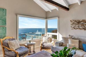a living room with a view of the ocean at OCEAN FRONT Beach HOUSE! Private Stairs to SAND! in Laguna Beach