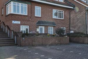 a brick building with stairs in front of it at Haus-Weite-Sicht in Wittdün