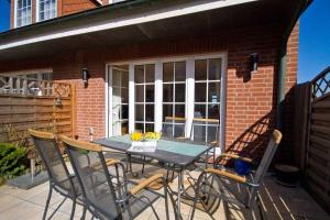 a table and chairs sitting on a patio at Haus-Weite-Sicht in Wittdün +6 photos