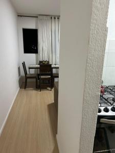 a kitchen and dining room with a table and a dining room at Apartamento in Paranoá
