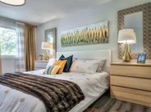 a bedroom with a large bed and a dresser at Vihome001C1-4-Bedrooms(Fairview Mall and 401+DVP) in Toronto