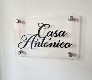 a sign on a wall with the name of a restaurant at Casa Antonico in Garachico