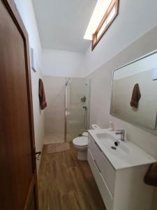 a bathroom with a sink and a toilet and a mirror at Casa Antonico in Garachico