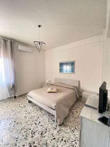 a bedroom with a bed and a flat screen tv at Nuova Luna in Salerno