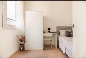 a bedroom with a desk and a bed and a deskictericter at Quiet Love Suites in Barcelona
