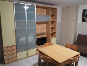 a room with a table and a cabinet and a couch at CASA GENTILE in Giovinazzo