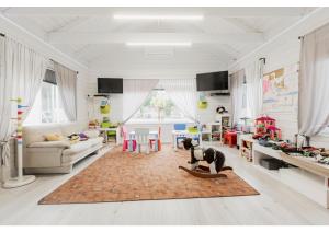 a living room with a dog on a rug at Morska Gąska- domki letniskowe in Mielenko