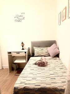 a small bedroom with a bed and a desk at Quiet Love Suites in Barcelona