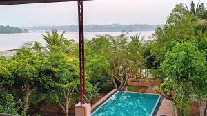 a swimming pool with a view of the water at Jayaa Villas Bolgoda - Full Villa in Panadura