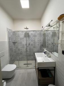 a bathroom with a shower and a toilet and a sink at LE SORELLE in Rome