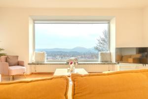 a living room with a large window and a couch at Haus in exklusiver Lage in Krems an der Donau