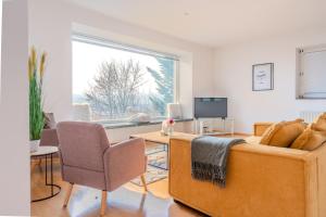 a living room with a bed and a large window at Haus in exklusiver Lage in Krems an der Donau