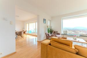 a living room with a couch and a large window at Haus in exklusiver Lage in Krems an der Donau