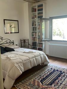 a bedroom with a bed and a book shelf at LE SORELLE in Rome