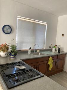 a kitchen with a sink and a stove top oven at Cerca de todo en San Jerónimo in Monterrey