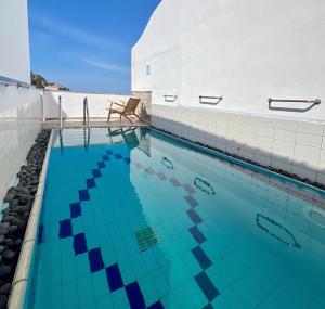 a swimming pool with blue water in a building at Villa Sunset Signature - Private Pool & Sea View in Hydra