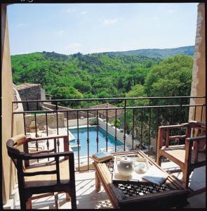 a balcony with a view of a swimming pool at Le Capitaine in Bonnieux
