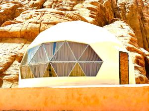 a dome tent in front of some rocks at Jori Luxury Camp in Wadi Rum