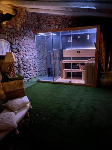 a living room with a television and a tub in a room at Maison Du Reve Scario in Scario