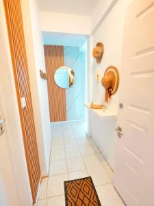 a hallway with a door and a tile floor at Fibonacci Beachfront Apartment in Flic-en-Flac