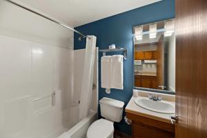 a bathroom with a white toilet and a sink at WoodSpring Suites El Paso in El Paso