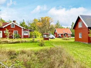 a group of houses and a red barn at Idyllic Getaway with Private Beach in Abbetorp