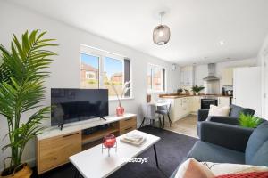 a living room with a couch and a tv at 1 Sarah House by Truestays - 2 Bedroom Apartment - FREE Wifi & Parking in Manchester