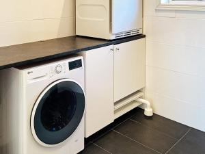 a washer and dryer in a kitchen with a microwave at 4 star holiday home in FAGERFJÄLL-By Traum in Åkervik