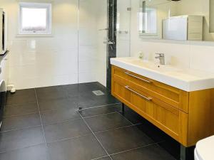 a bathroom with a sink and a shower at 4 star holiday home in FAGERFJÄLL-By Traum in Åkervik +17 photos