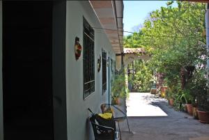 a child sitting in a chair outside of a house at Hostal Delmy in Suchitoto