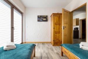 Posteľ alebo postele v izbe v ubytovaní ARAMIKA apartamenty