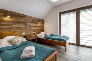 Posteľ alebo postele v izbe v ubytovaní ARAMIKA apartamenty