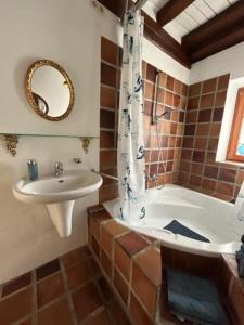 a bathroom with a sink and a bath tub and a sink at Gemütliches Scheunenfachwerkhaus nahe Frankfurt mit Glasfaser und Klima in Bad Soden am Taunus +52 photos