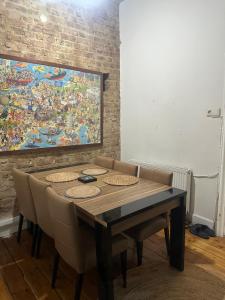 a dining room table with chairs and a painting on the wall at Youkali hause in Istanbul