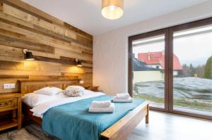 Posteľ alebo postele v izbe v ubytovaní ARAMIKA apartamenty