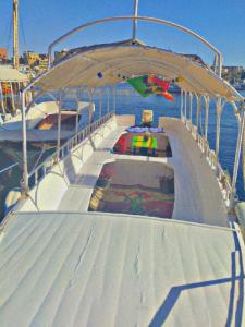 a deck of a boat with a pool on the water at charming nubian guest house in Aswan