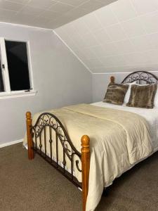 a bedroom with a large bed with a window at Cozy 4 bd house in Pitt in Pittsburgh