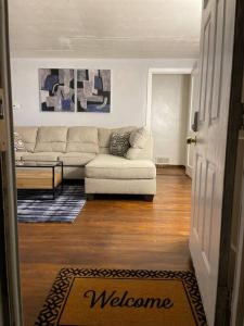 a living room with a couch and a rug at Cozy 4 bd house in Pitt in Pittsburgh